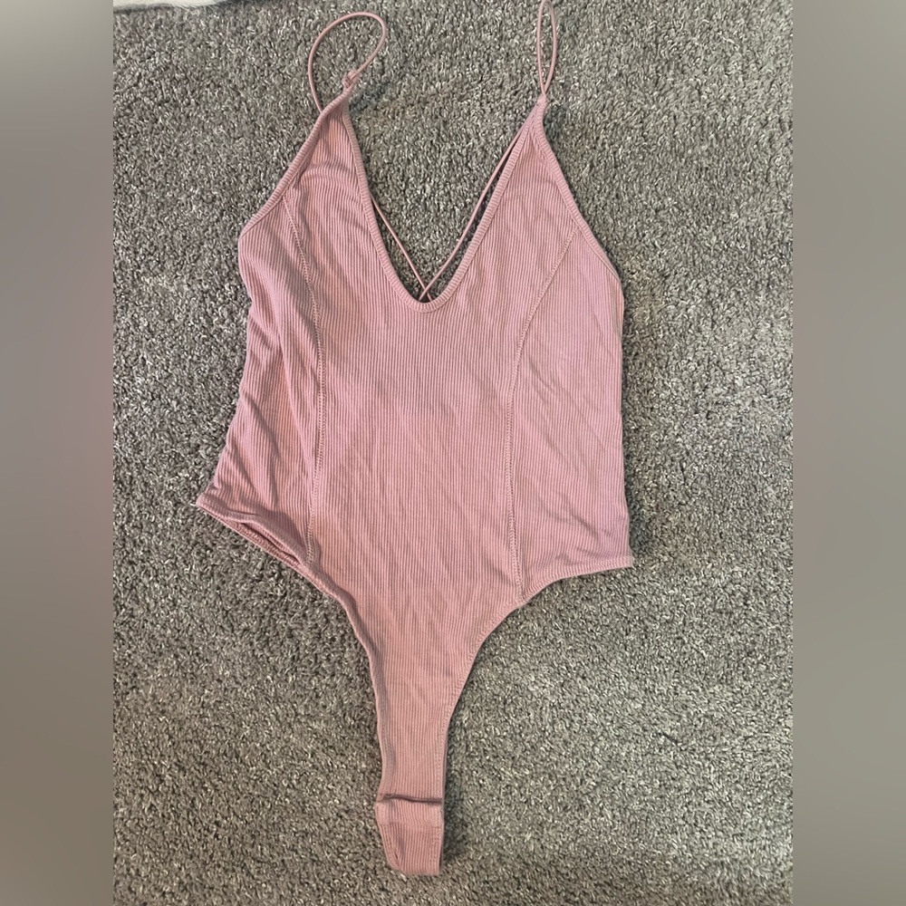 pink body suit. size medium